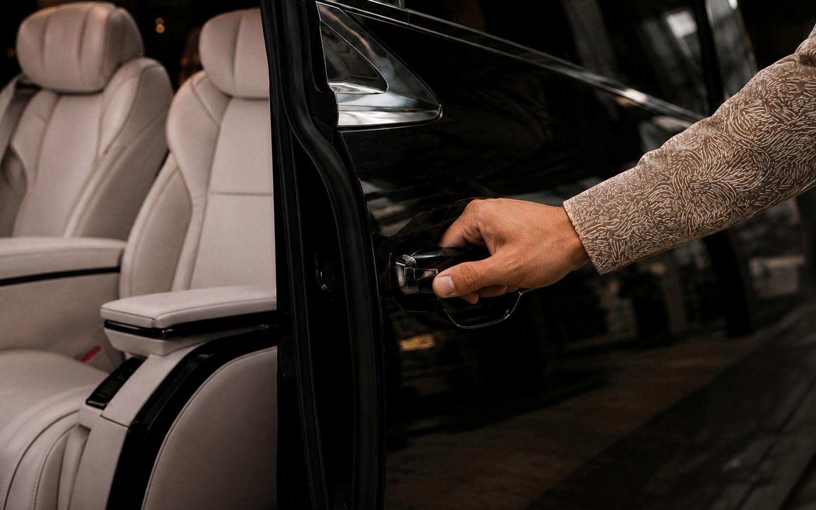 Chauffeur opening the door of a luxury MPV